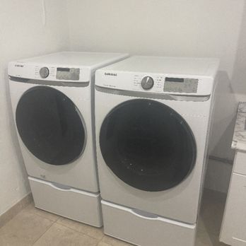 Laundry appliances photographed during a Leo Technician service visit.