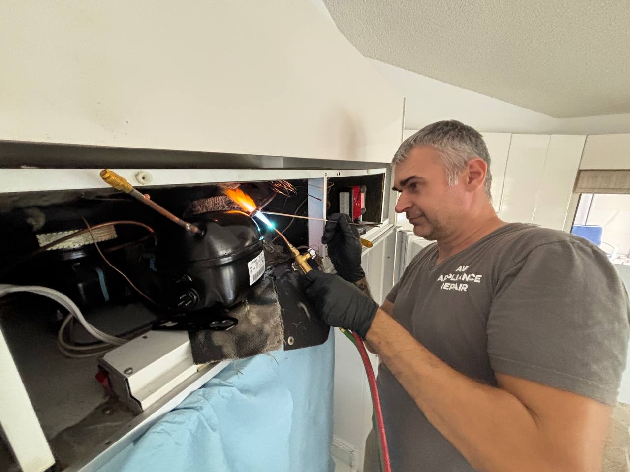 Leo working on a Sub-Zero compressor replacement.